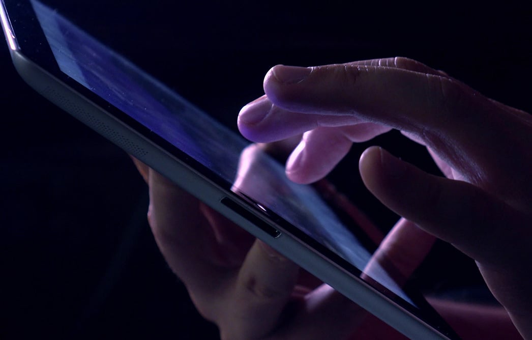 Close-up of a hand scrolling on a tablet screen
