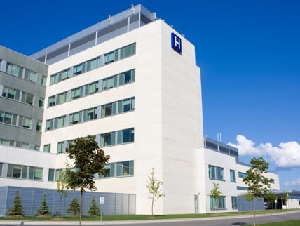 Exterior of a modern hospital building on a sunny day