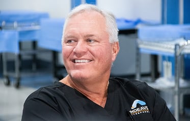 Dr. Brent Norris smiling in a surgical lab